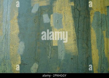 Abstract design of green and yellow paint covering graffiti on a concrete water tank Stock Photo