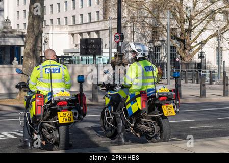 Victoria Embankment, Westminster, London, UK. 7th Apr, 2023. The New Scotland Yard headquarters of the Metropolitan Police in London has been vandalised with a red line of paint sprayed along its front wall. Motorcycle police officers outside Stock Photo