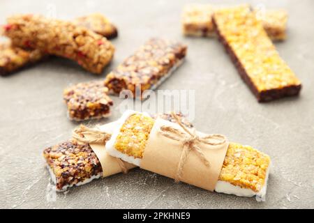 Granola bars on grey background. Diet and breakfast. Top view Stock Photo
