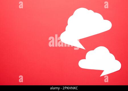 White paper speech bubbles on red background. Top view Stock Photo