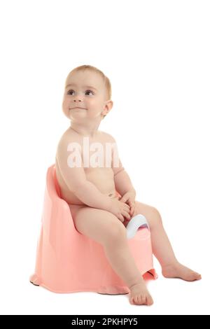 Smiling baby on chamber-pot isolated on white background. Top view Stock Photo