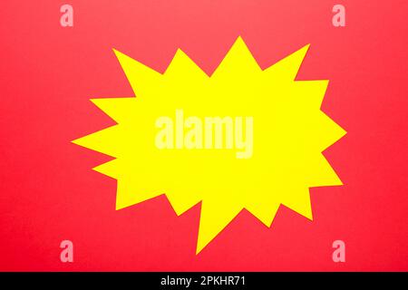 Yellow paper speech bubbles on red background. Top view Stock Photo
