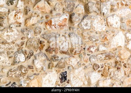 Empty old stonewall material with beige cement background texture. Vintage rough stone wall, blank masonry or floor backdrop. Copy space. Stock Photo
