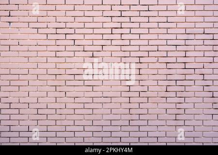 Empty brickwall background texture. Brickwork with row of pink color brick. Building exterior with horizontal geometric design. Copy space Stock Photo