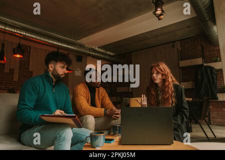 Three young smart diverse multiracial coworkers creating new marketing strategy while working remotely Stock Photo