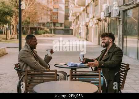 Good looking male business people having fun conversation and laughing. First morning coffee Stock Photo