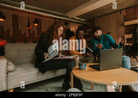 Unsuccessful code execution. Disappointed male programmer working with his diverse coworkers. He cannot find a solution Stock Photo