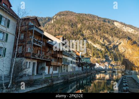 Interlaken, Switzerland, February 10, 2023 Historic old buildings at the waterfront in the city center Stock Photo