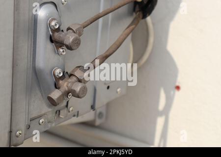 Air conditioning outdoor unit with a view of freons carrying lines. Coolant Transport Infrastructure Featuring Flexible Tubes Stock Photo