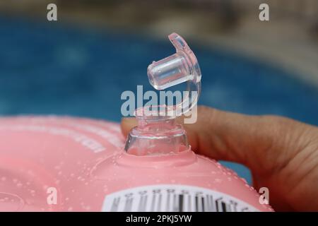 Front focus of a open inflatable valve of a swimming tube. Summer vacation concept. Swimming tube parts Stock Photo