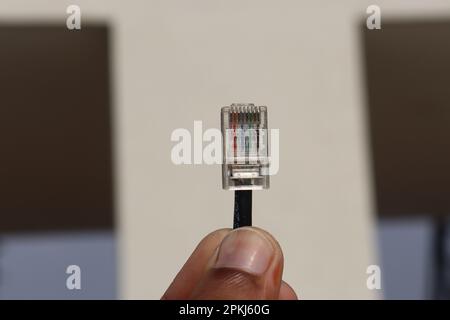 Detailed Close-Up of Ethernet Cable Connector Pin held in the hand Stock Photo