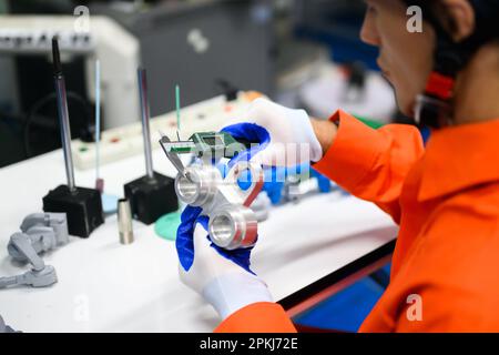 Industrial engineers workers working and checking machine factory Stock Photo