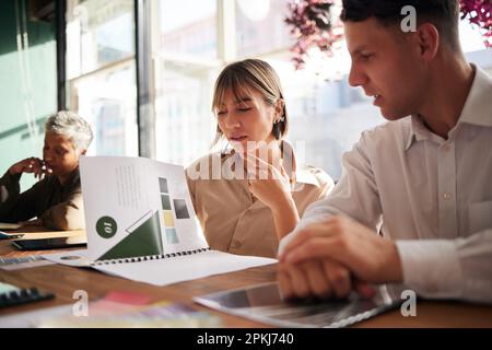 Documents, woman or businessman in meeting reading a portfolio for project planning together in office. Team collaboration, paperwork or focused Stock Photo