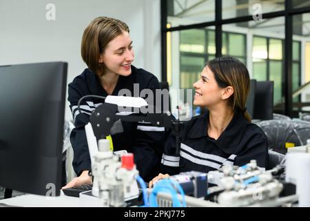 Industrial technicians working with machine maintenance in factory Stock Photo