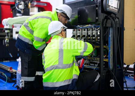 Electrician working with terminal power cable and controlled equipment Stock Photo