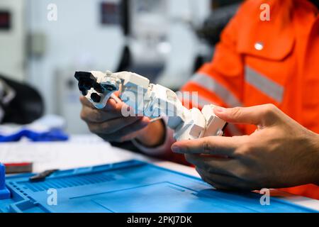 Engineer working and solving problems on machine at industrial plant Stock Photo