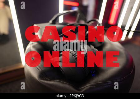 Casino online concept. Professional headphones with microphone and vr glasses for video games and cyber sports on background. Stock Photo