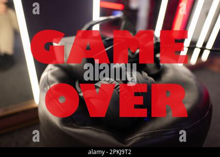 Game over concept. Professional headphones with microphone and vr glasses for video games and cyber sports on background. Stock Photo