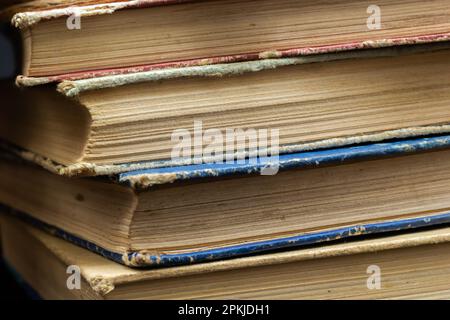 Book background. Stack of books in the library. Old yellow pages of paper books. Learning and knowledge. Stock Photo