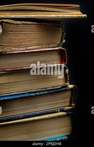 Book background. Stack of books in the library. Old yellow pages of paper books. Learning and knowledge. Stock Photo