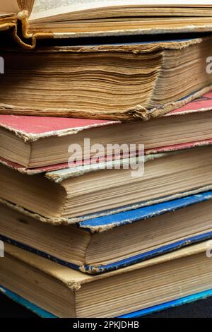 Stack of hardcover old books with on a dark background. Bookshelf shop, Knowledge publications, literature. Bookish bookstore bookstore. Stock Photo