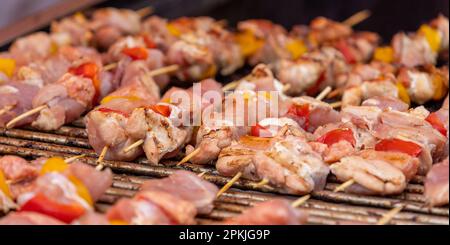 banner of delicious meat and vegetable skewers cooking on coals Stock Photo
