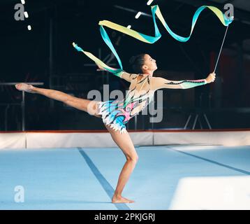 Ribbon, gymnastics and flexible woman stretching in performance