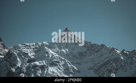 Snowcapped mountain against blue sky Stock Photo