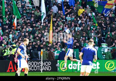 Celtic fans in the stands as Rangers players warm up before the cinch Premiership match at Celtic Park, Glasgow. Fan safety and security issues led to the decision by Celtic and Rangers to have home supporters only for the cinch Premiership match at Parkhead and the post-split game at Ibrox at a date yet to be determined. Picture date: Saturday April 8, 2023. Stock Photo