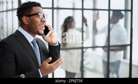 Young African American man holding his smartphone Stock Photo