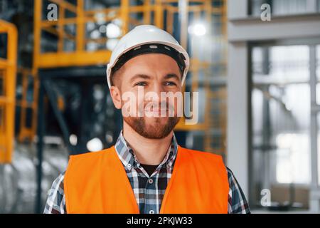 Portrait of construction worker in uniform is in the factory Stock Photo