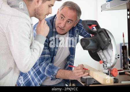 student in carpentry class using circular saw Stock Photo