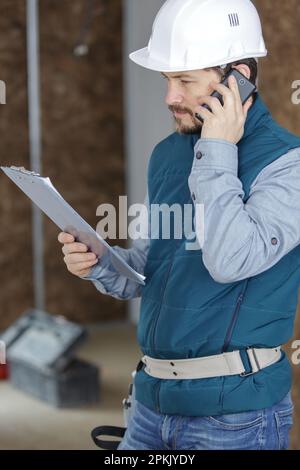 smiling foreman talking on cell phone Stock Photo