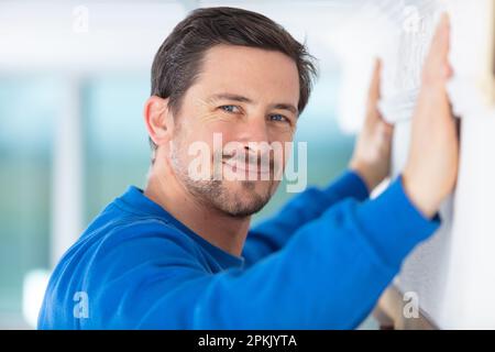 handsome young man using spirit level Stock Photo