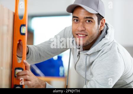engineer checking wall with spirit level for level Stock Photo