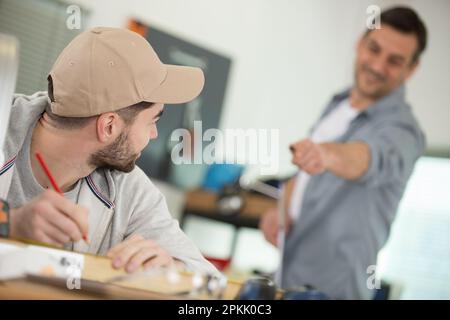 handsome young man in the electronic workshop holding digital tablet Stock Photo