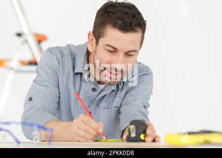 male hands making curtain rail measurements Stock Photo