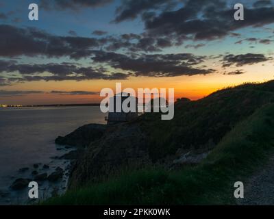 Dusk at the Sutton Martello Tower with the crescent moon peeking through the clouds Stock Photo