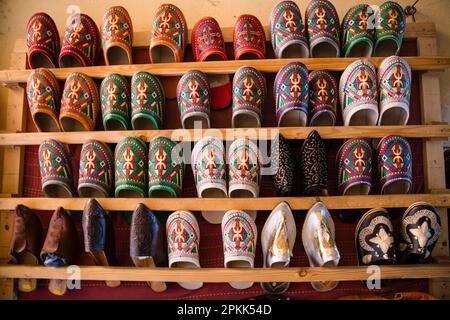 Closeup view of a wall of colorful babouche slippers for sale in Fez Medina Morocco Stock Photo