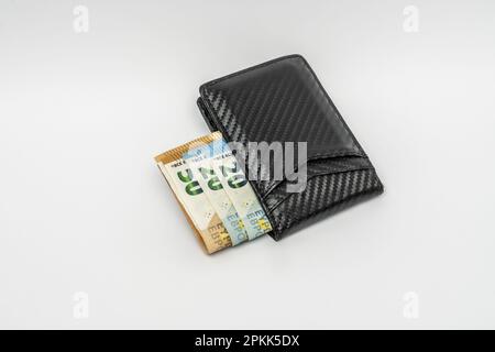 A black carbon fiber braided wallet filled with euro bills Stock Photo