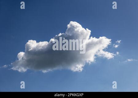 single cloud in a blue sky in the spring in the UK Stock Photo