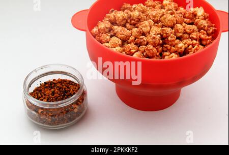 Chili Covered Popcorn Made in Red Microwave Container Stock Photo