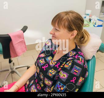 fair-haired woman sitting in a chair at the dentist Stock Photo