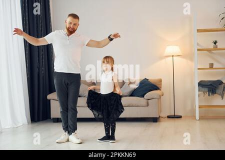 Father posing with cute baby daughter on grunge background Stock Photo by  ©belchonock 148526551