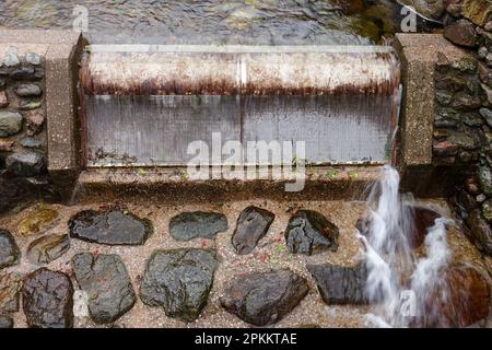 Hydroelectric power generation water capture inlet weir with metal filter mesh sieve on Stickle Ghyll, Langdale, Cumbria, UK Stock Photo
