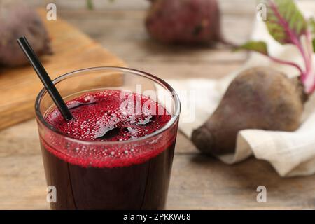 Freshly made beet juice in glass on wooden table, closeup Stock Photo