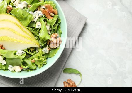Tasty salad with pear slices on light grey table, flat lay. Space for text Stock Photo