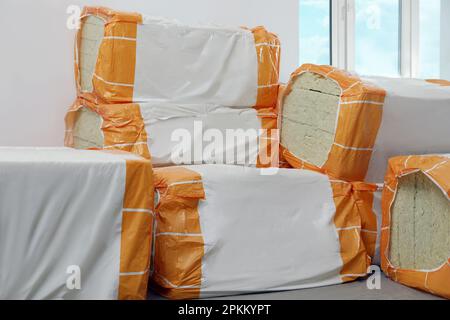 Packages of thermal insulation material in room Stock Photo