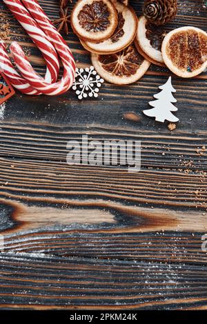 Candies and slices of oranges. Christmas background with holiday decoration. Stock Photo