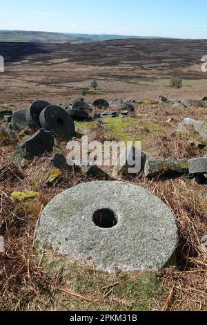 Old abandoned millstones at Stanage Edge, a gritstone cliff in the Peak District, Derbyshire, England, UK Stock Photo